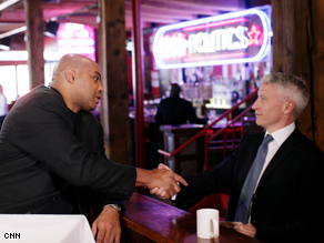 TNT Analyst Charles Barkley and Anderson Cooper shake hands at the CNN Grill in Denver, Co.