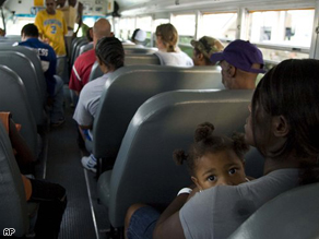 Residents wait on an evacuation bus at the Lake Charles Civic Center.