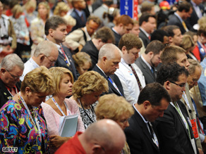 Delegation members in prayer at the Republican National Convention 2008 in St. Paul, Minnesota, Monday. The political jamboree's opening day turned into a Hurricane Gustav fundraising effort.
