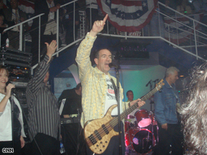 Former Arkansas Gov. Mike Huckabee plays the guitar with his band, Capitol Offense, at a party during the RNC-week festivities.
