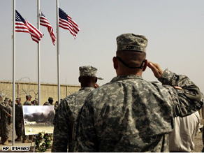 U.S. Army soldiers salute three American flags, representing the three sites of the September 11 terrorist attacks on the United States, at a ceremony to mark the seventh anniversary at Camp Liberty in Baghdad.