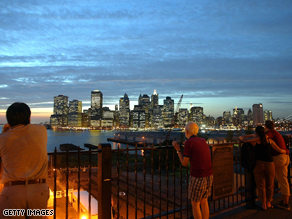 Visitors to the Brooklyn Promenade look out at Lower Manhattan, September 10, 2002.