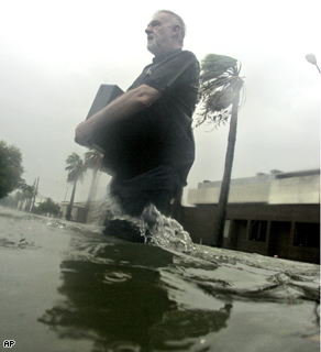 A man clutches a brief case as he makes his way through high water created by hurricane Ike's storm surge in downtown Galveston, Texas
