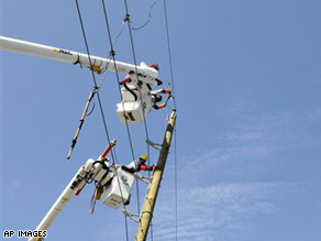 Florida Light and Power Co. linemen work to restore power in the Houston area.