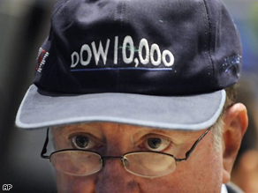 Trader Arthur Cashin wears a 'Dow 10,000' hat, one that was given out when the Dow Jones Industrial Average first hit 10,000 on March 29, 1999, as he works on the NYSE trading floor Monday.