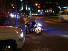 A policeman directs traffic while awaiting a motorcade in Nashville.