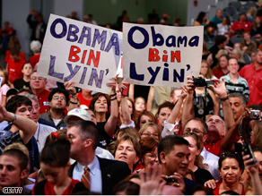 Supporters hold up signs during a rally for John McCain and Sarah Palin at the Virginia Beach Convention Center on Monday.