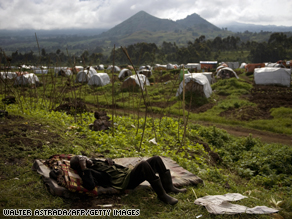 A man sleeps on a mattress on the patio of a school near the Kibumba refugee camp, on October 19.