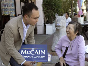 Truong Diep, left, speaks with Vietnamese-American women Nguyen Thanh, 72, as Diep campaigns for Sen. John McCain Wednesday, in the Little Saigon area of Westminster, CA.