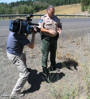 Washington State Dept. of Natural Resources Officer Gary Margheim shows CNN photographer Tom Larson where he found a critical clue -- the arsonist's 'sparking' device.