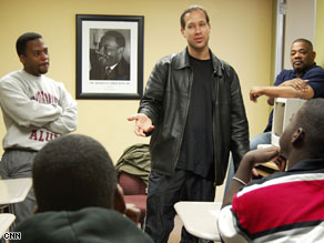 Selah speaking with young me n who are members of his non-profit mentoring group, A Guiding Hand