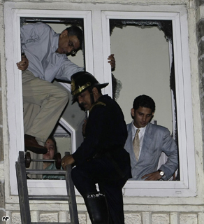 A firefighter rescues guests of The Taj Hotel in Mumbai on Thursday after teams of heavily armed gunmen stormed the luxury hotel.