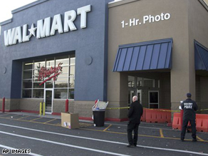 Nassau County Police examine the front of the Wal-Mart on Long Island, N.Y., Friday, Nov. 28, 2008, after a temporary Wal-Mart worker died when trampled by shoppers.