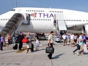 Passengers arrive at Bangkok Wednesday on board a Thai Airways jet.