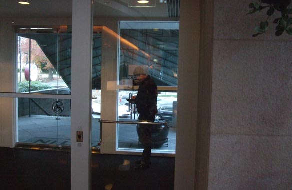 Eric Lanford getting syched-up and warm listening to his iPod in a hotel lobby vestibule