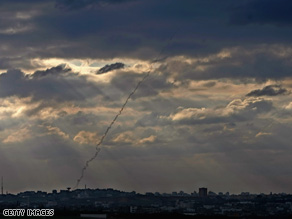A missile launched from northern Gaza heads toward an Israeli town on Tuesday.