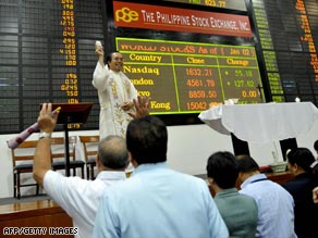 A priest officiates a mass at the Philippine Stock Exchange Monday.