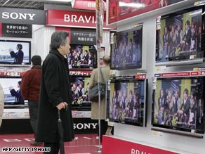 Customers check Sony's Bravia brand LCD TVs at an electronics shop in Tokyo, Japan.