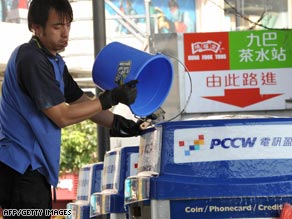 A worker cleans a PCCW telephone booth in January in Hong Kong, China.
