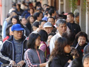 People line up to receive $108 U.S. dollars worth of shopping vouchers in Taipei, Taiwan, last month.
