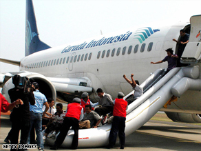 People posing as passengers take part in an anti-terrorist drill at Sukarno-Hatta airport in Jakarta.