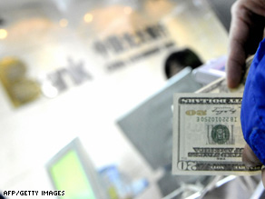 A customer exchanges U.S. dollar notes at a bank in Beijing, China, on Tuesday.