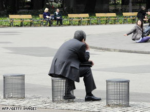 A businessman sits on an improvised chair at a Tokyo park on Tuesday.