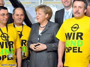 German Chancellor Angela Merkel speaks to employees of German carmaker Opel.