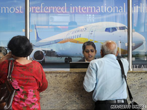Air travelers wait at the Jet Airways counter at the city airport in Mumbai on Tuesday.