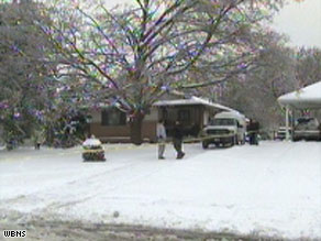 Police tape surrounds a Whitehall, Ohio, house, where a family of four was found dead Wednesday.