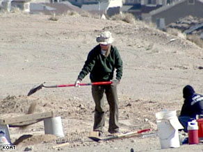 An Albuquerque, New Mexico, police forensics team member digs at the burial site.