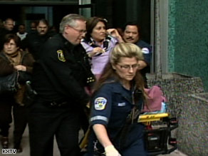 Paramedics wheel Judge Cinda Fox out on a stretcher after she was attacked during court in Stockton, California.