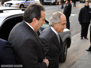 Disgraced financier Bernard Madoff, right, arrives at a federal courthouse Thursday.
