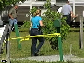 Police examine the scene where a domestic violence suspect engaged in a shootout with deputies.