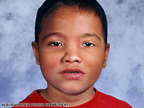 A boy visits the memorial for an unidentified child found buried in the sand of a playground.