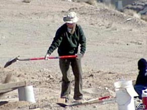 An Albuquerque, New Mexico, police forensics team member digs at the burial site.
