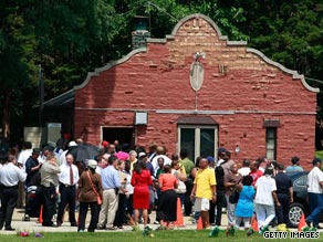 Family members and police gather outside the Burr Oak Cemetery office in Alsip, Illinois, on Wednesday.
