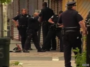 Police officers gather at the site of a shootout in Jersey City, New Jersey, on Thursday.