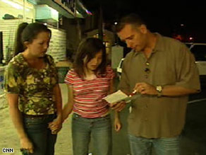 Marissa, with her mother close behind, practices walking through a store without grabbing, shouting or shoplifting.