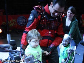 Eli Hummer, 3, gets to try out an oversized motorbike at the circus.