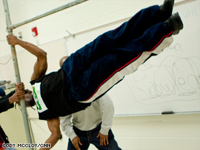 One of the Bartendaz, Metaphysics, performs the flag move during a demonstration at an Atlanta-area school.