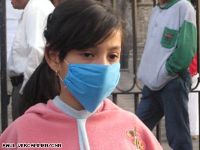 A girl in Mexico City wears a mask outside the Metropolitan Cathedral on Sunday. 