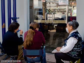 Relatives of flu patients wait oustside Mexico's National Institute of Respiratory Diseases.