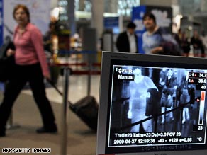 Quarantine%20officers%20monitor%20arrivals%20with%20a%20thermographic%20device%20at%20Bangkoks%20main%20international%20airport.