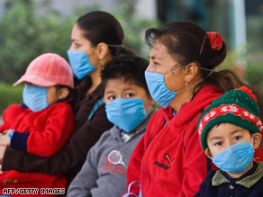 Quarantine officials at the Narita, Japan, airport go Wednesday to meet planes arriving from Mexico.