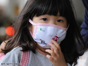 Don't pack your face masks just yet. Public health officials expect the 2009 H1N1 virus to linger a while.