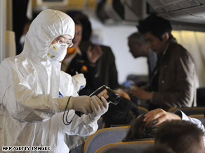 Chinese health authorities prepare to take temperatures of passengers on a plane from Germany this week.