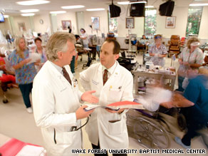 Dr. Barry Freedman, right, speaks with a colleague in a dialysis center at Wake Forest Baptist Medical Center.