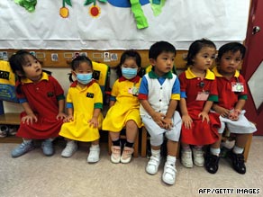 Kindergarten students, some wearing masks, attend school in a residential estate in Hong Kong on Thursday.