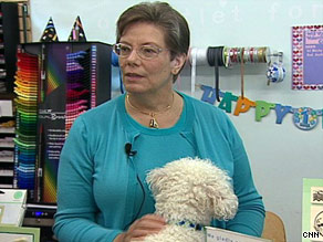 After an experimental cancer treatment, Linda Campbell has returned to work, with her dog Peanut.